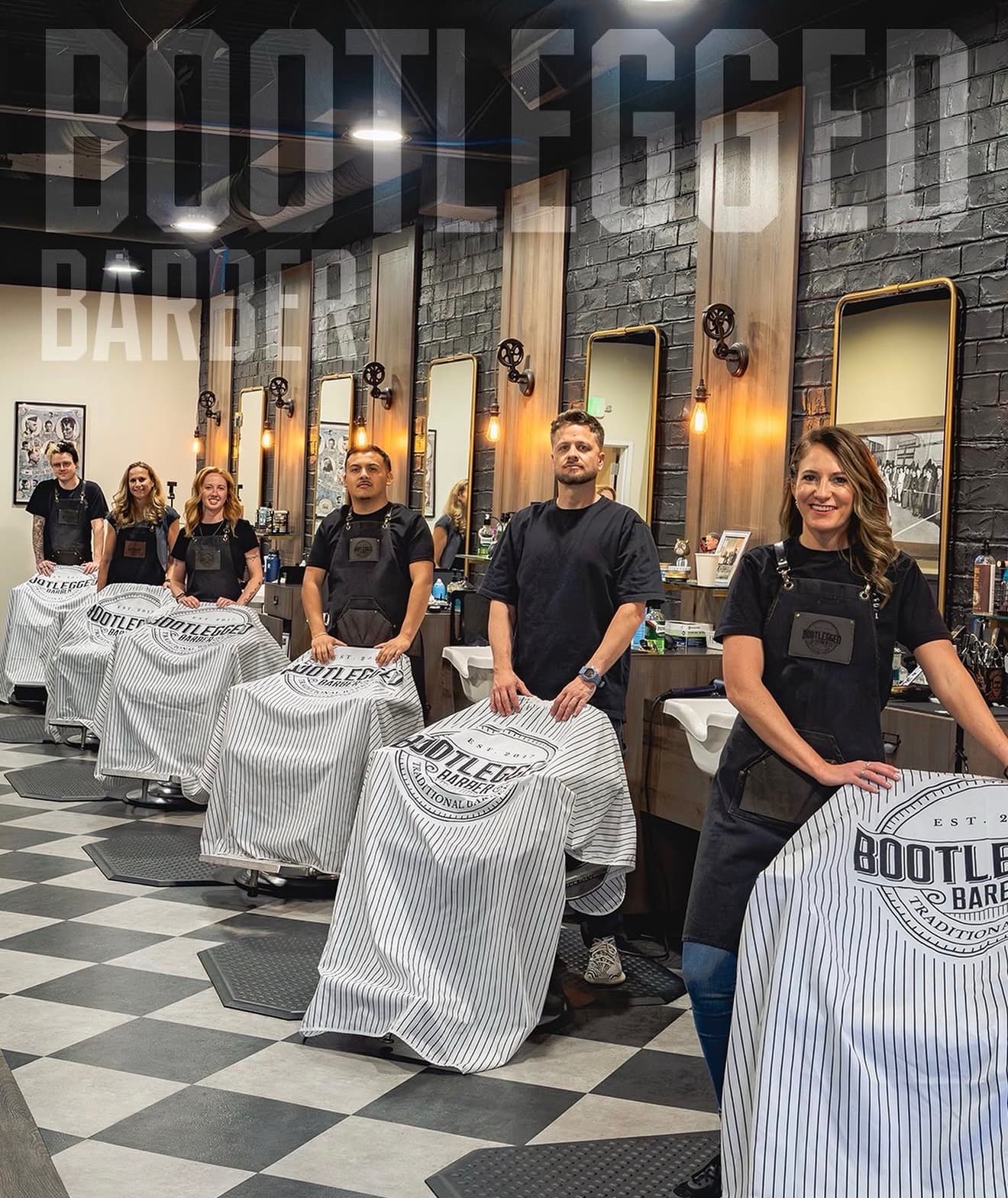 The team of barbers at Bootlegged Barber standing beside their chairs